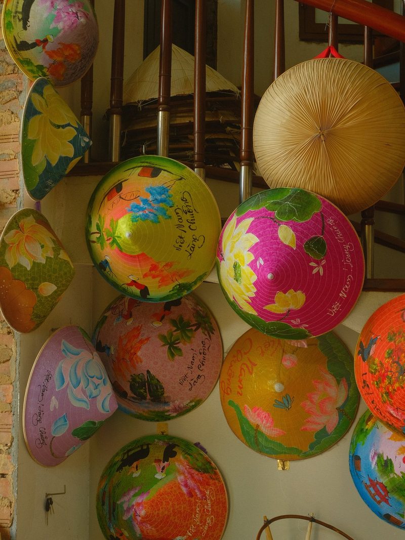 A collection of colorful, intricately designed hats on display in a shop, likely for sale.
