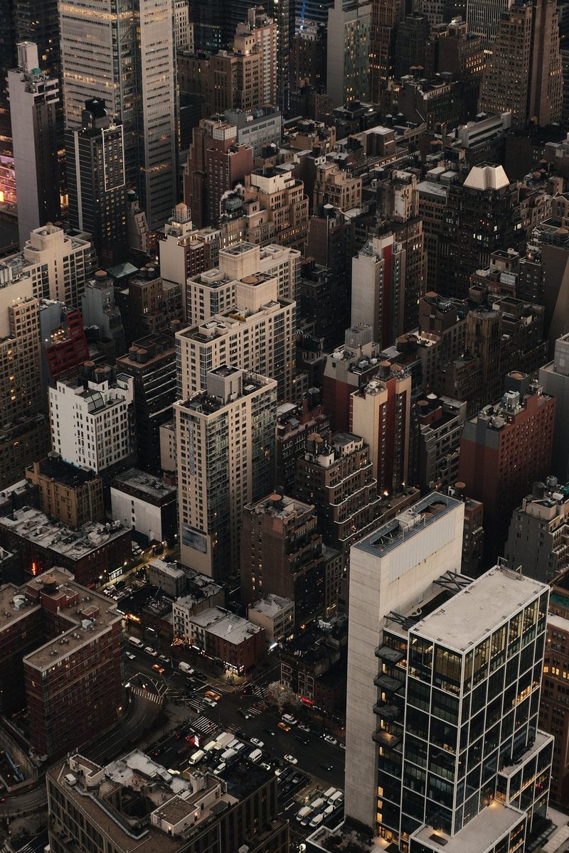 An aerial view of a densely populated urban area with numerous tall buildings and streets.