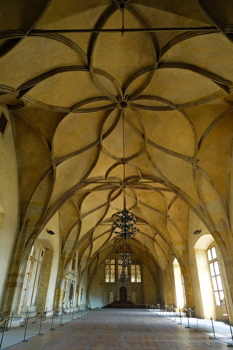 A large, ornate room with high ceilings and arched windows, possibly a historic building or church.